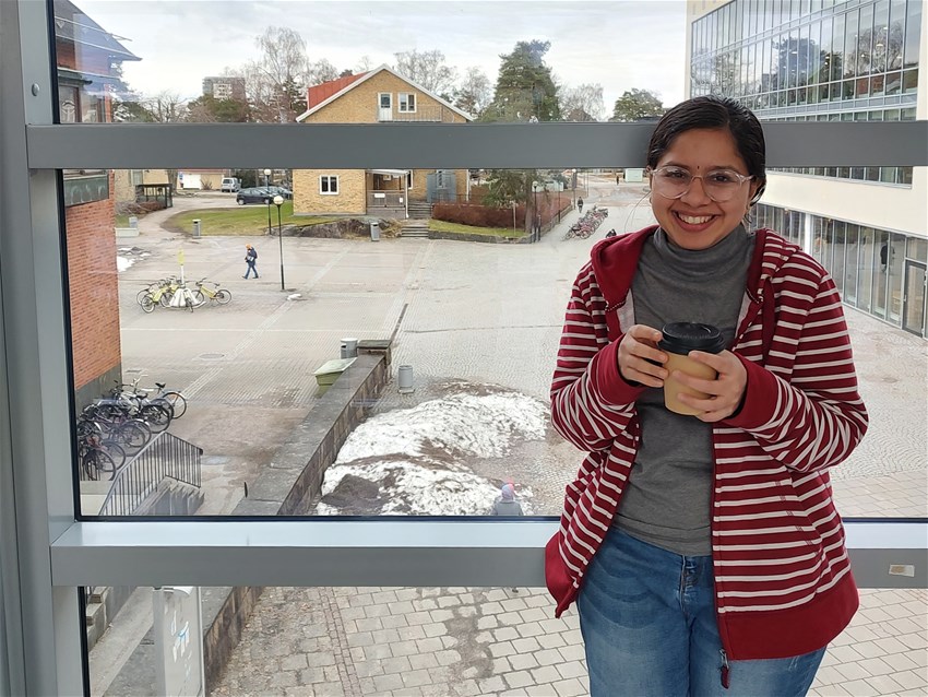 Woman standing holding a coffee in winter time