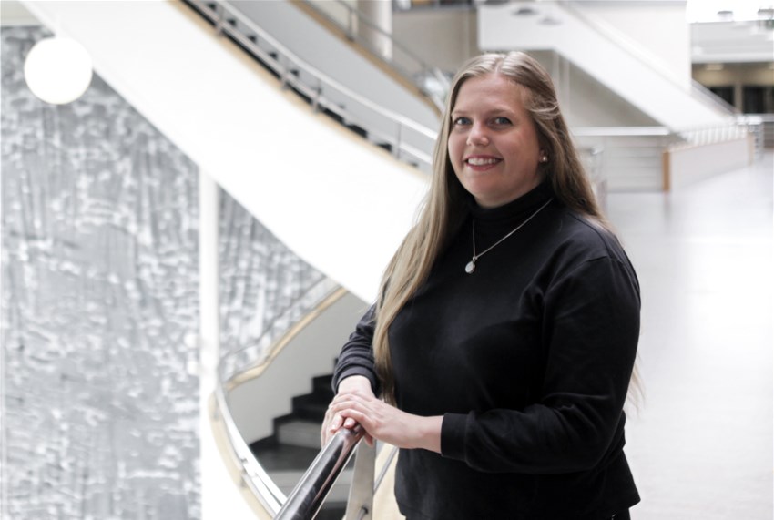 Woman standing in well lit hallway