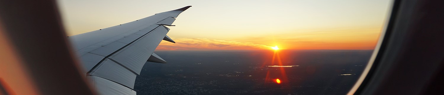 flygplansvinge mot solnedgång