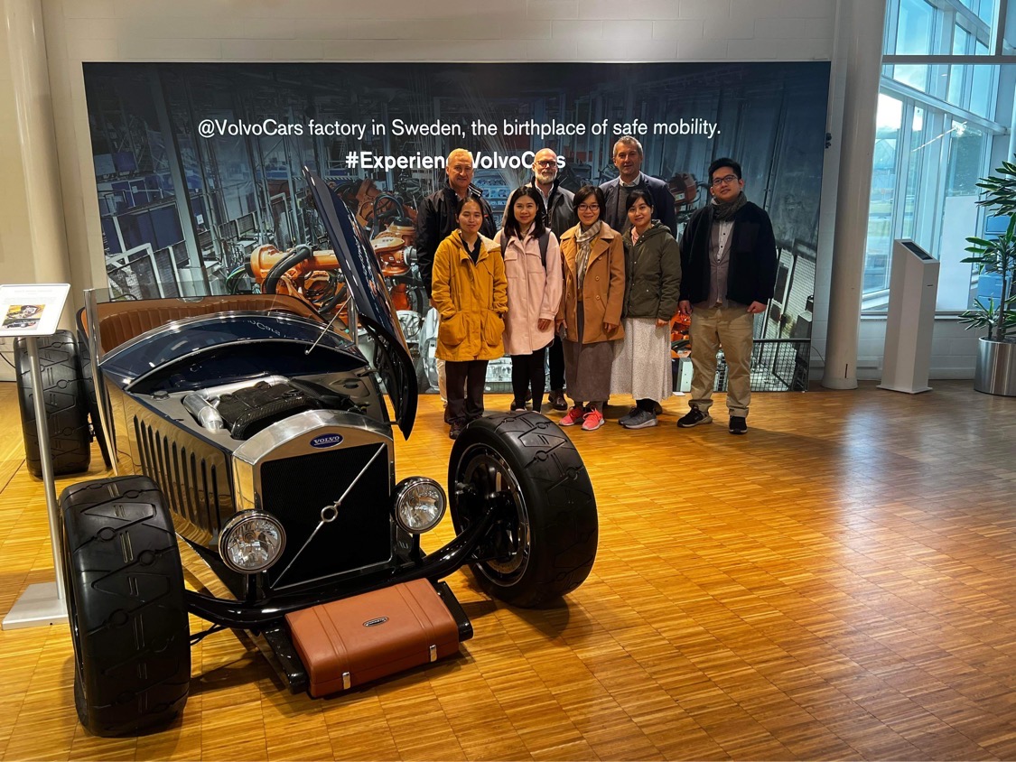 People standing by a special car. 