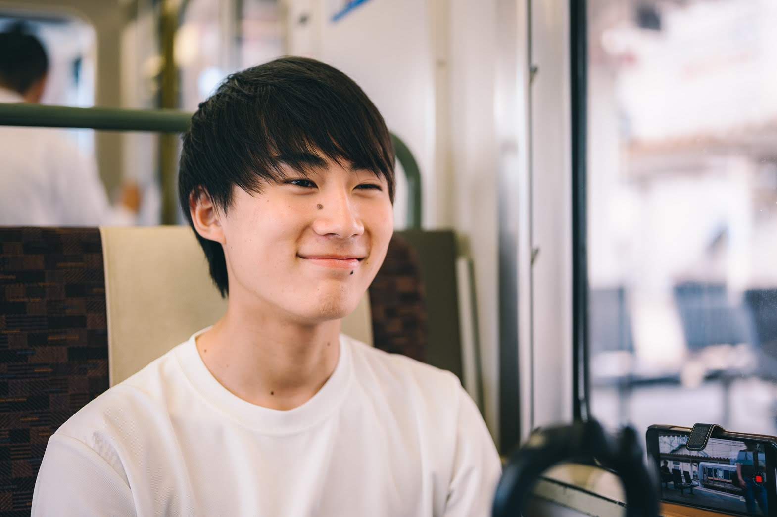 Taichi sits on train