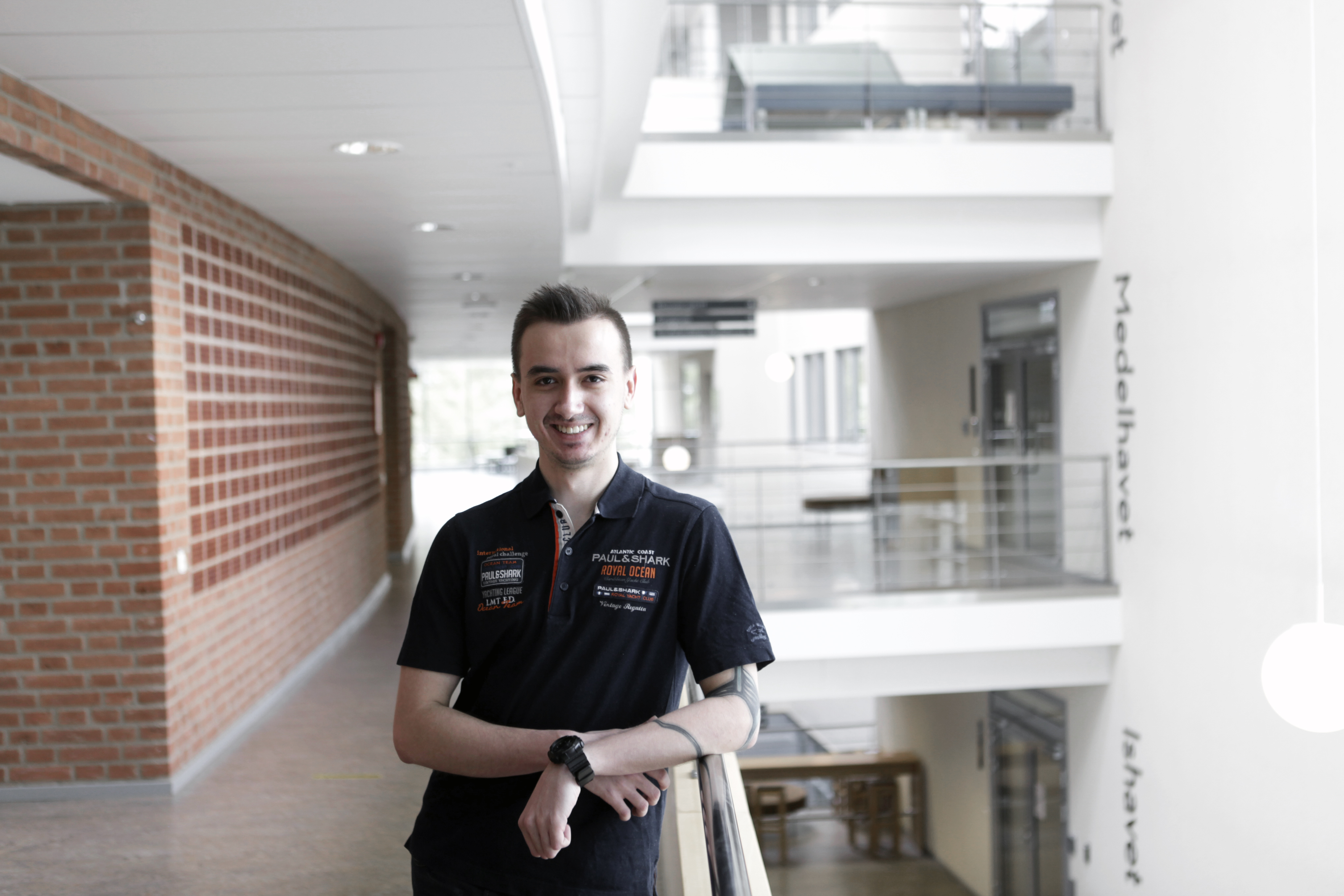 A man standing in a hallway. 